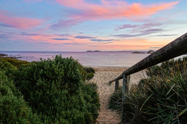 A sunset on a beach in Murramarang National Park near a camping area called North Head Campground