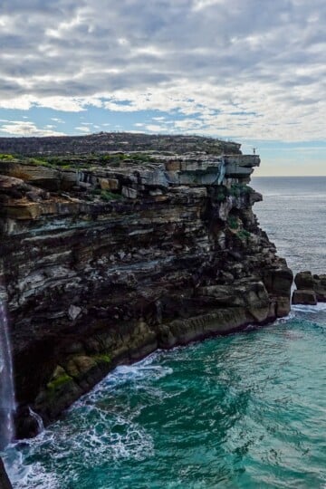 A waterfall plummets into the ocean in Sydney's Royal National Park