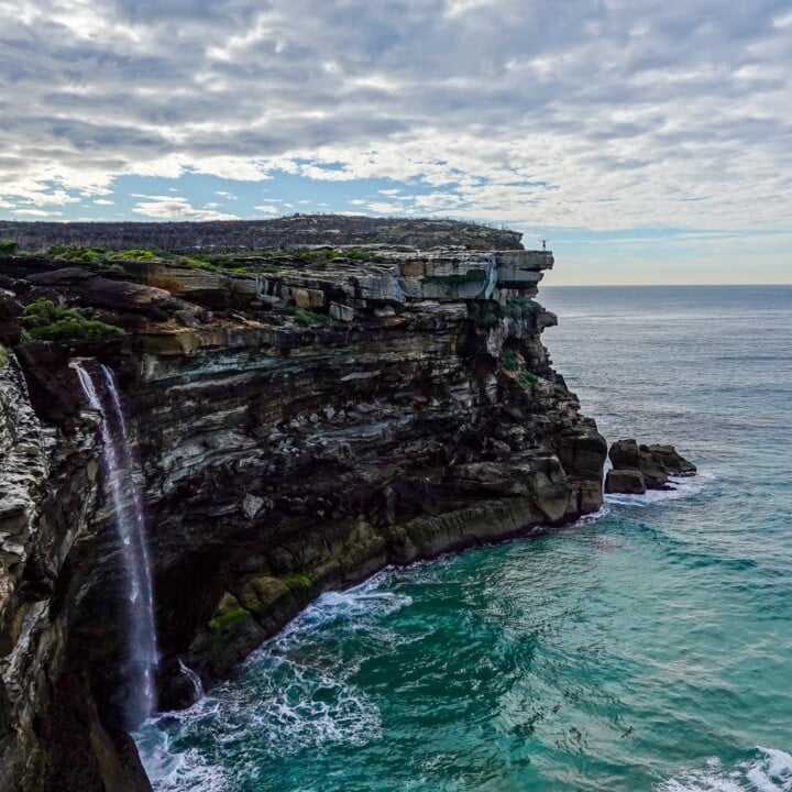 A waterfall plummets into the ocean in Sydney's Royal National Park