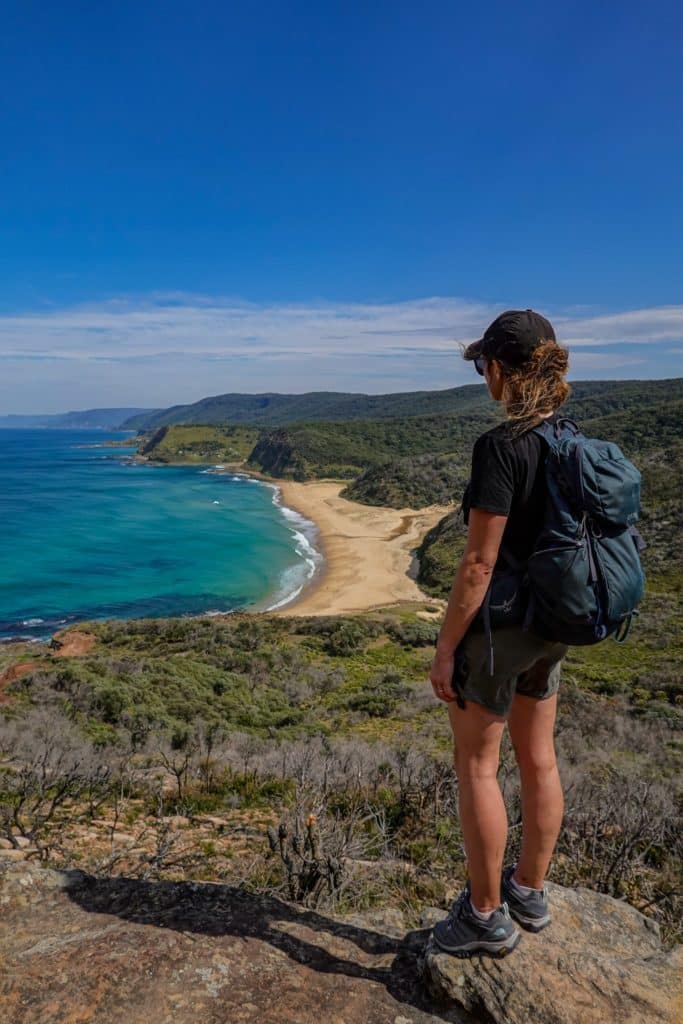 Beck enjoys the views of Garie and Little Garie Beach. Long stretches of beach are surrounded by bushland, golden sand and clear blue skies.
