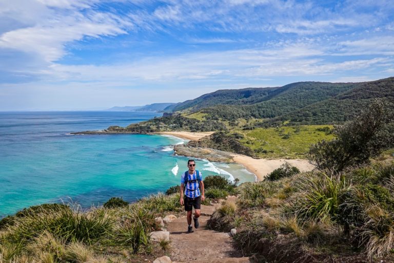 Man walk along the Royal National Park coastal track with sea views in Sydney
