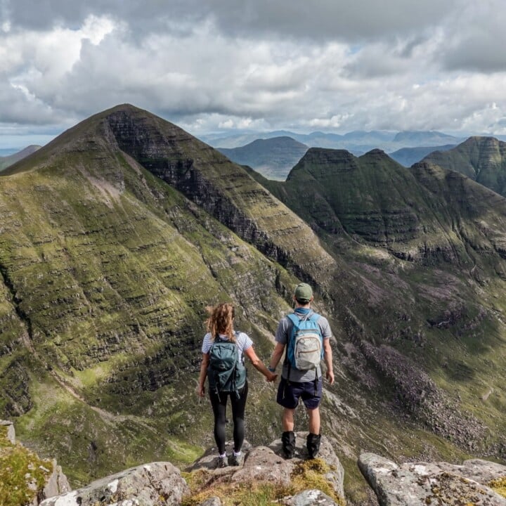 Dan an Beck stand atop of Tom Na Gruagaich at Beinn Alligin in Torridon, one of the best hikes on the NC500