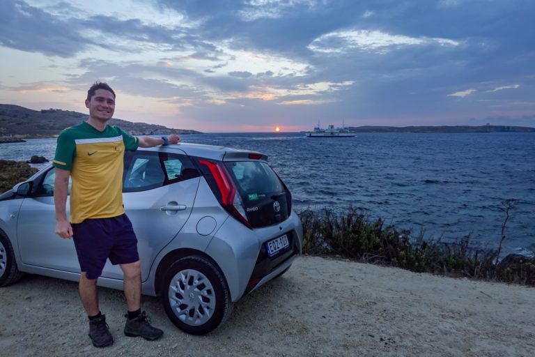 Dan stands by a car covered by Discover Cars Insurance