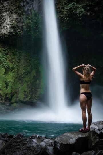 Beck stands at the base of La Fortuna Waterfall
