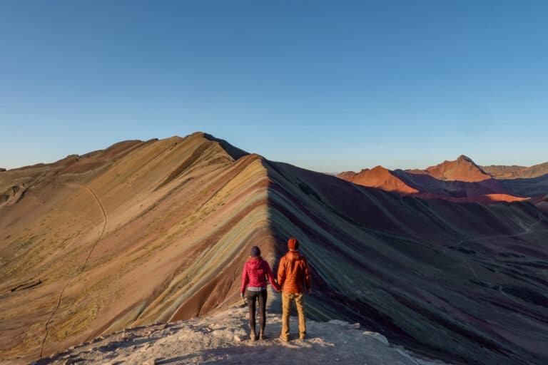 Dan and Beck stand at Rainbow Mountain in Peru