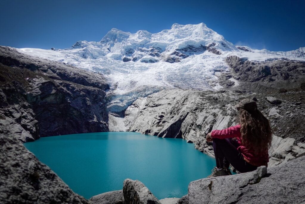 Beck sits and admires Laguna 513 in the Codillera Blanca, near Huaraz