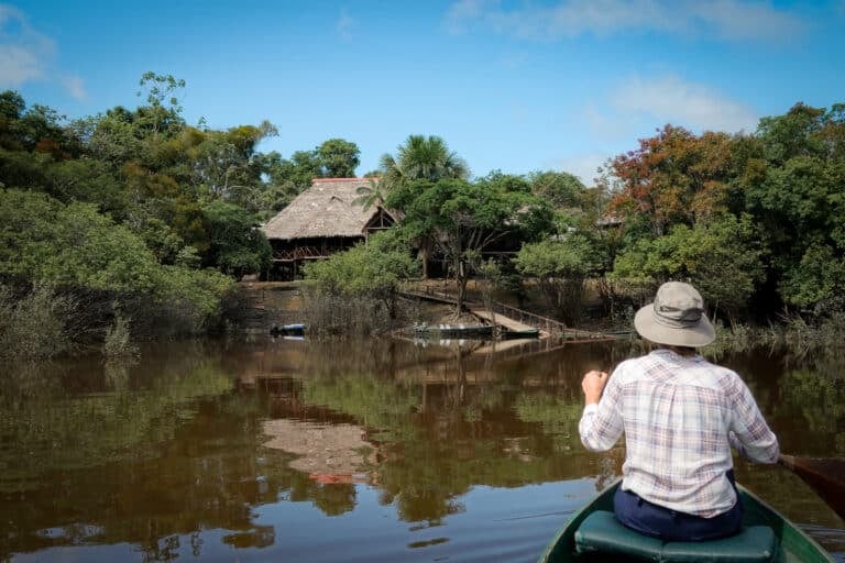 Beck paddles towards Amazonia Expeditions' Amazon Research Center Lodge on the Tahuayo River
