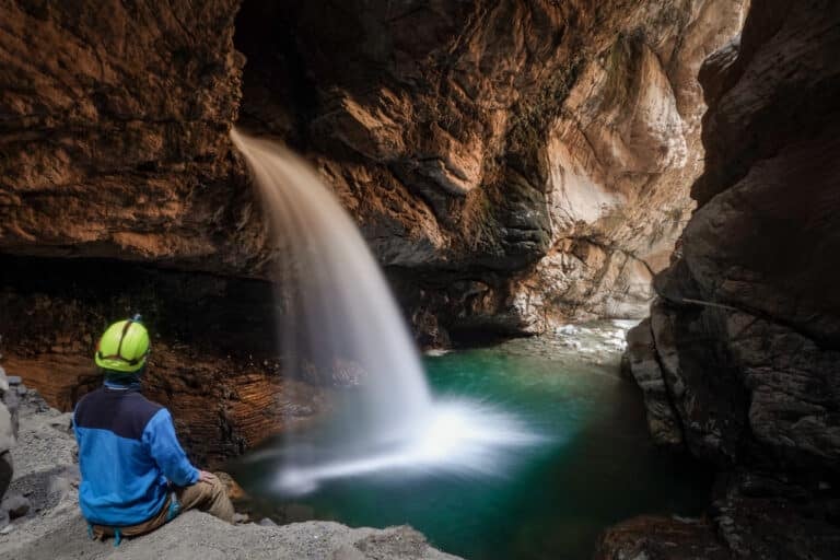 Dan sits and marvels at Sheke Waterfall, found in Cañon de Autisha
