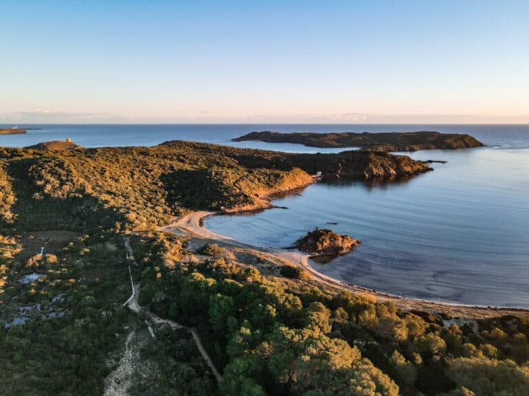 Platja Es Grau at sunrise, before seeing Cala Presili, Platja d'en Tortuga and Cala Tamarells des Sud on the walk to Faro de Favaritx