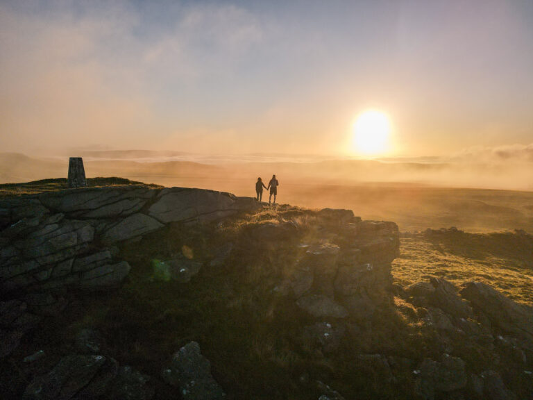 Dan and Beck watch sunrise at the Bowland Knotts