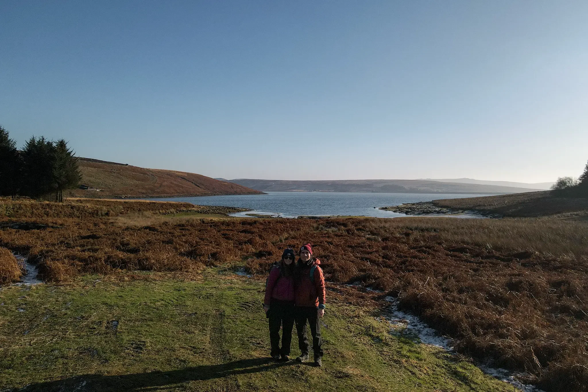 Dan and Beck stand in front of Grimwith Reservoir during a walk around it