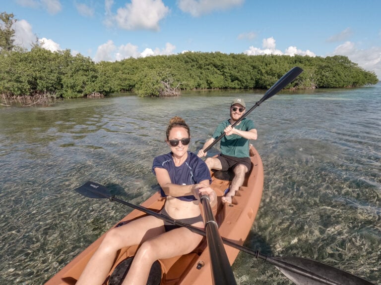 Beck and Dan kayak near The Split in Caye Caulker, Belize