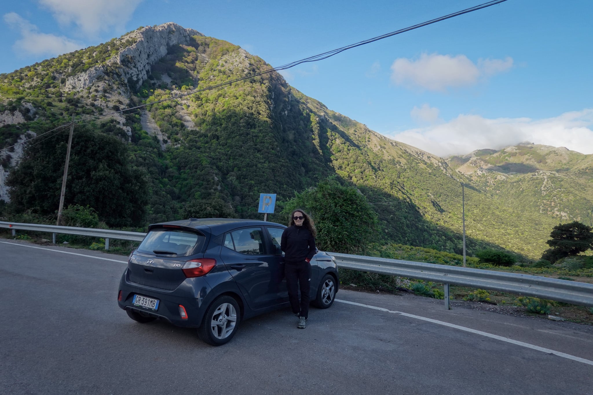 Beck stands by a rental car covered with Discover Cars Insurance