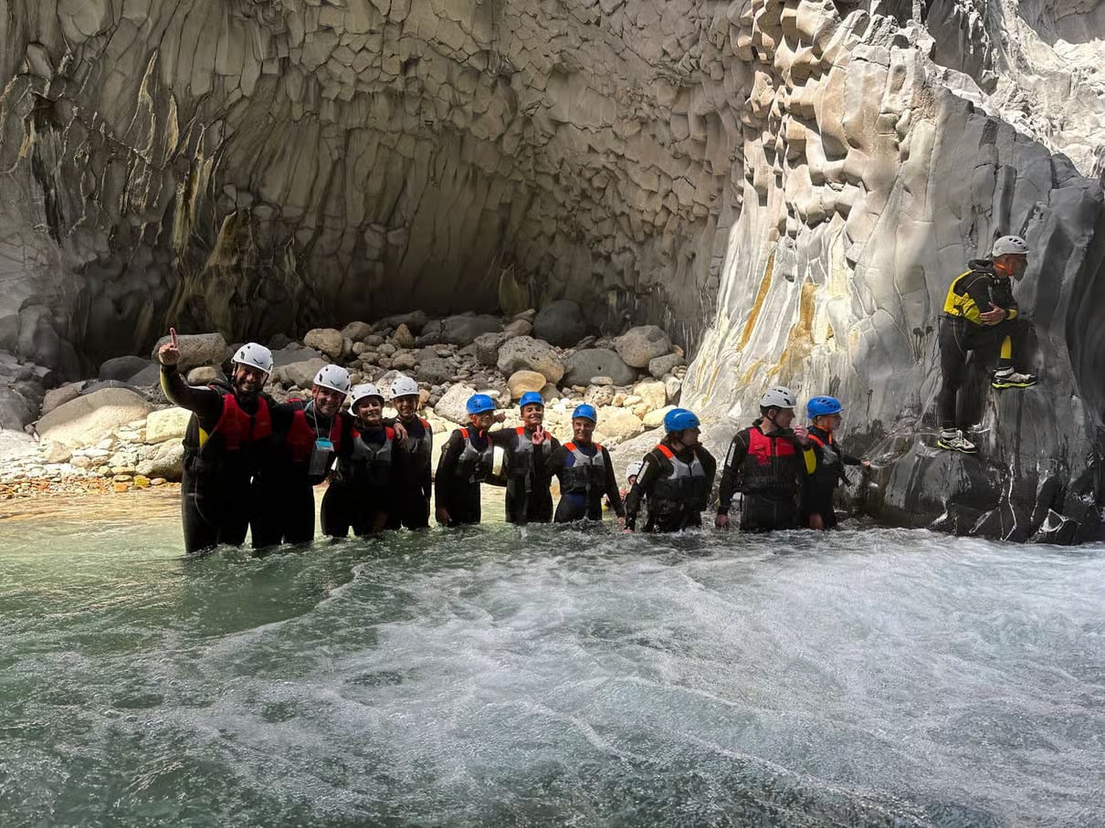 A group of people body rafting in Alcantara Gorges