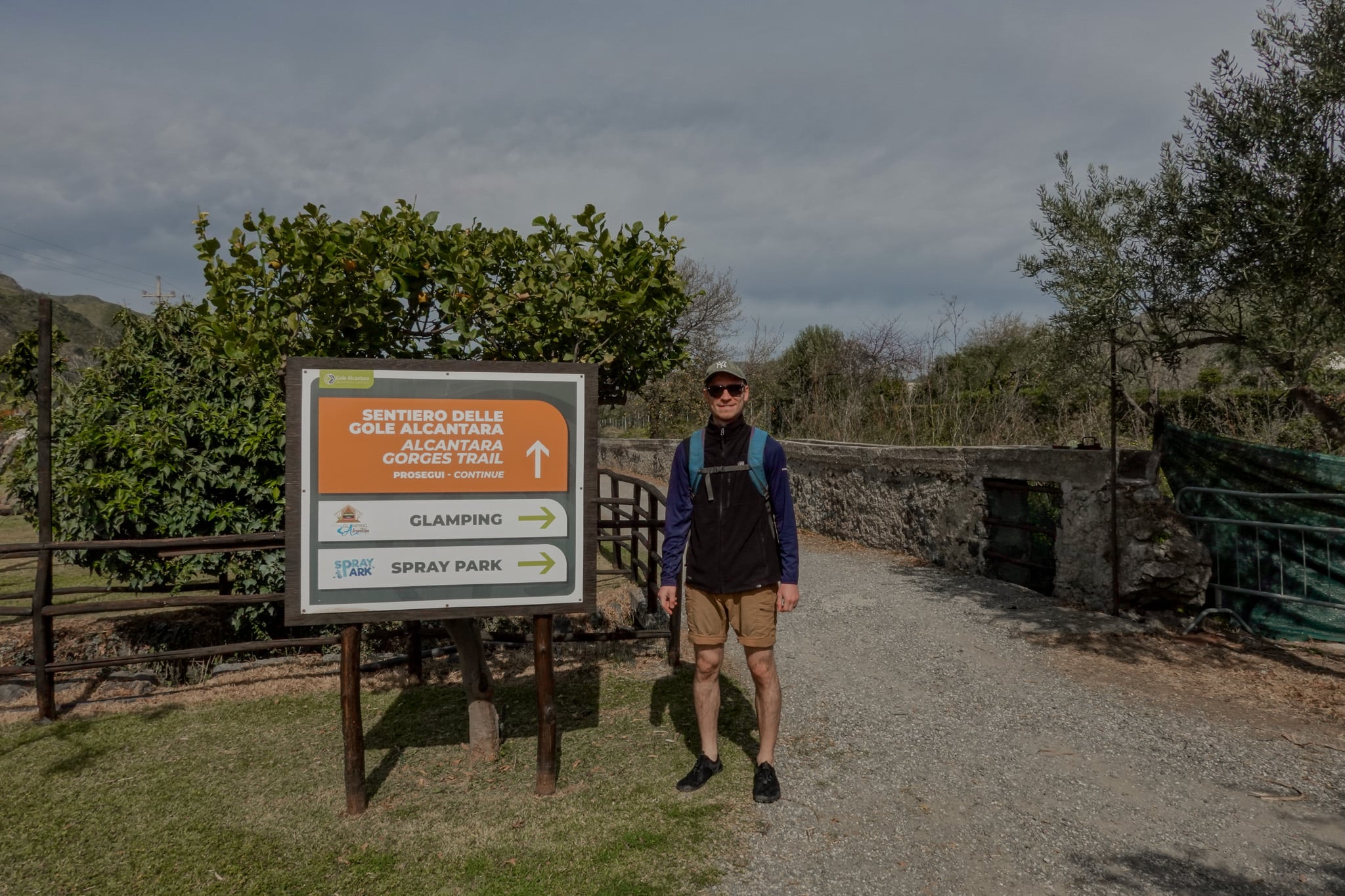 Dan stands by a sign showing the direction of the Alcantara Gorges Trail