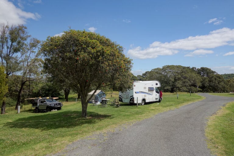 A motorhome and camping gear at at a campsite called Killalea Campground in Killalea Regional Park