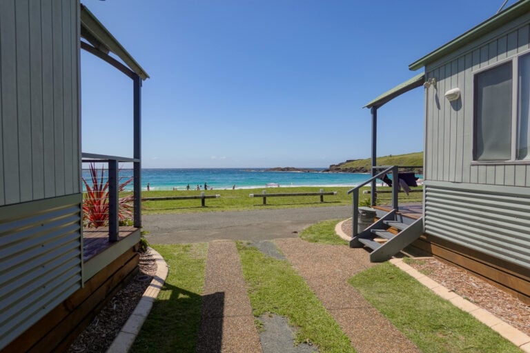 Views of a beach from a holiday park (AKA a caravan park) , in Kiama, which also features campsites