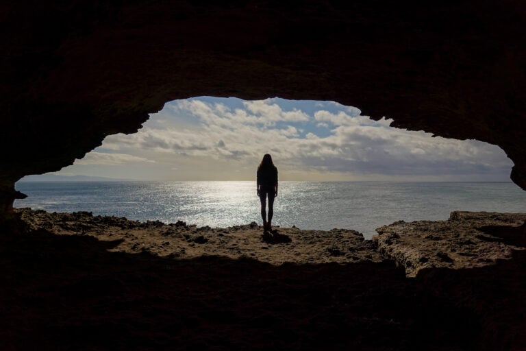 Woman stands at opening of Gosangs Tunnel