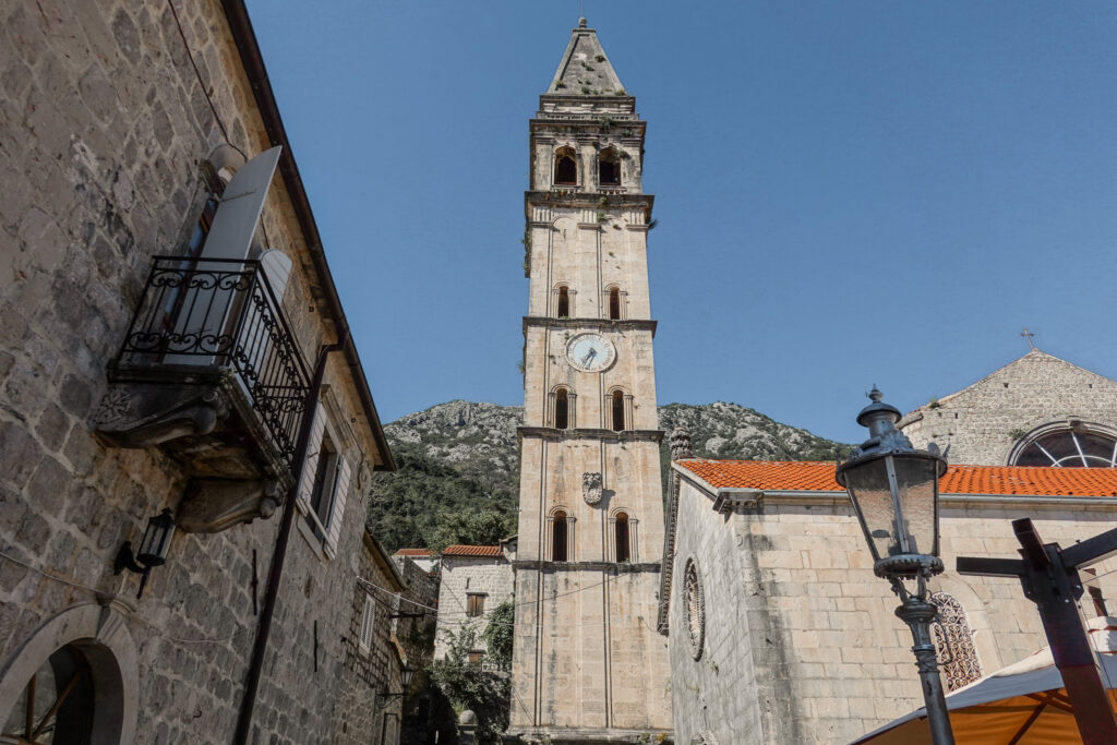 Church of Saint Nicholas against a blue sky and mountain backdrop