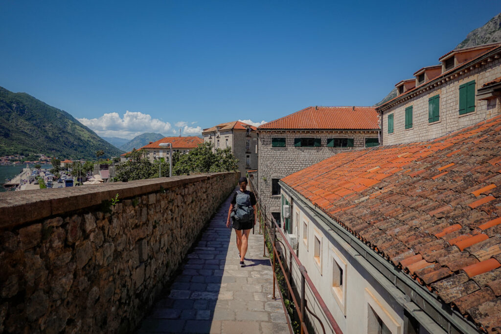Hiker walks the old city walls in Kotor Montenegro