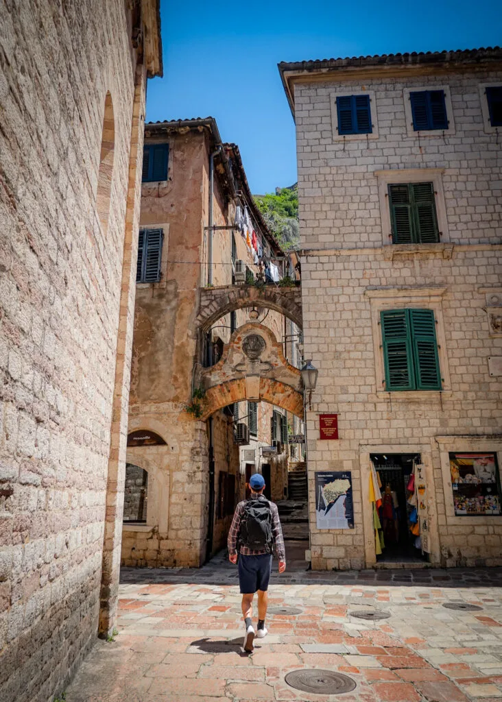 Man wanders the narrow streets of Kotor Montenegro