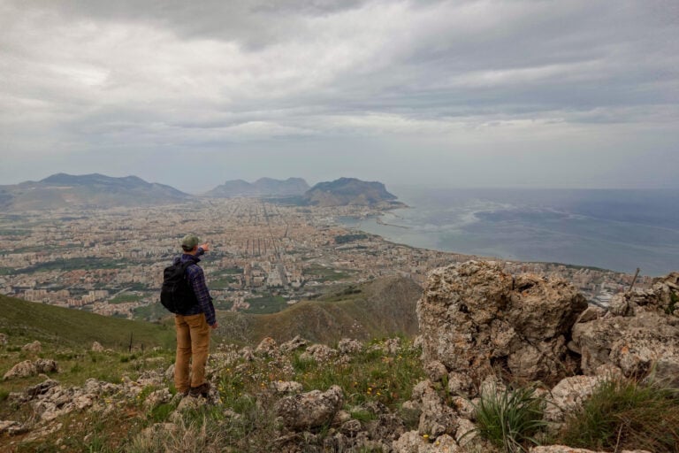 Dan points towards the town of Palermo from a mountain called Monte Grifone