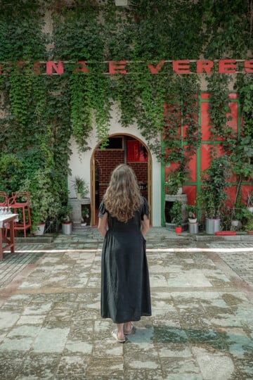 Beck at an entrance at a winery called Kantina e Veres Isak