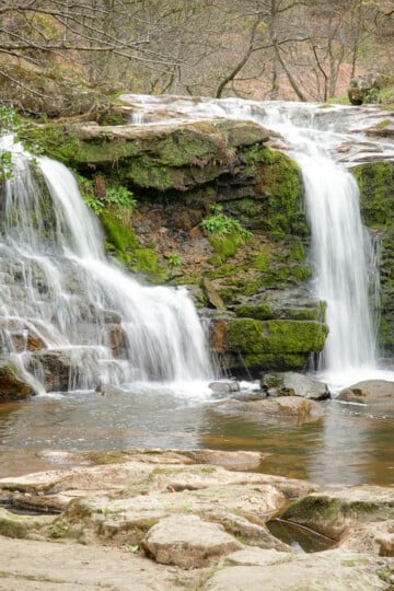 Dan stands and admires a waterfall called Water Arc Foss in the North York Moors