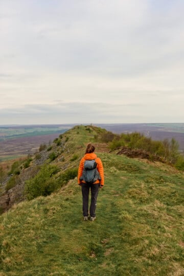 Beck stands still on a hill called Hawnby Hill during a walk on a cloudy morning