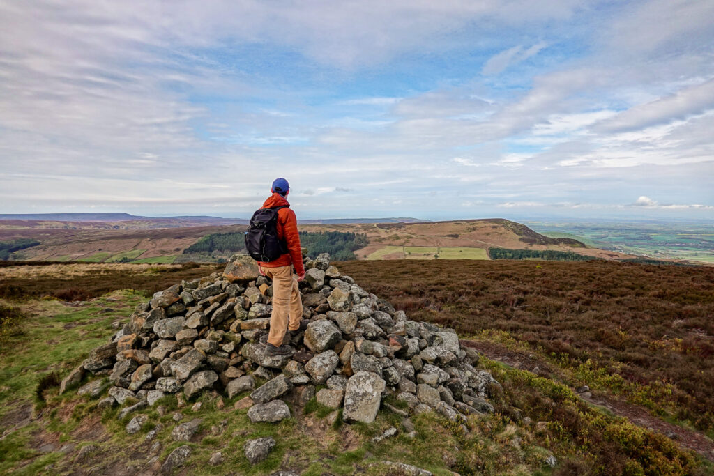Dan stands on a rock cairn
