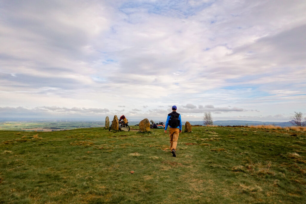 Dan walks towards a small circle of stones called the Lord Stones