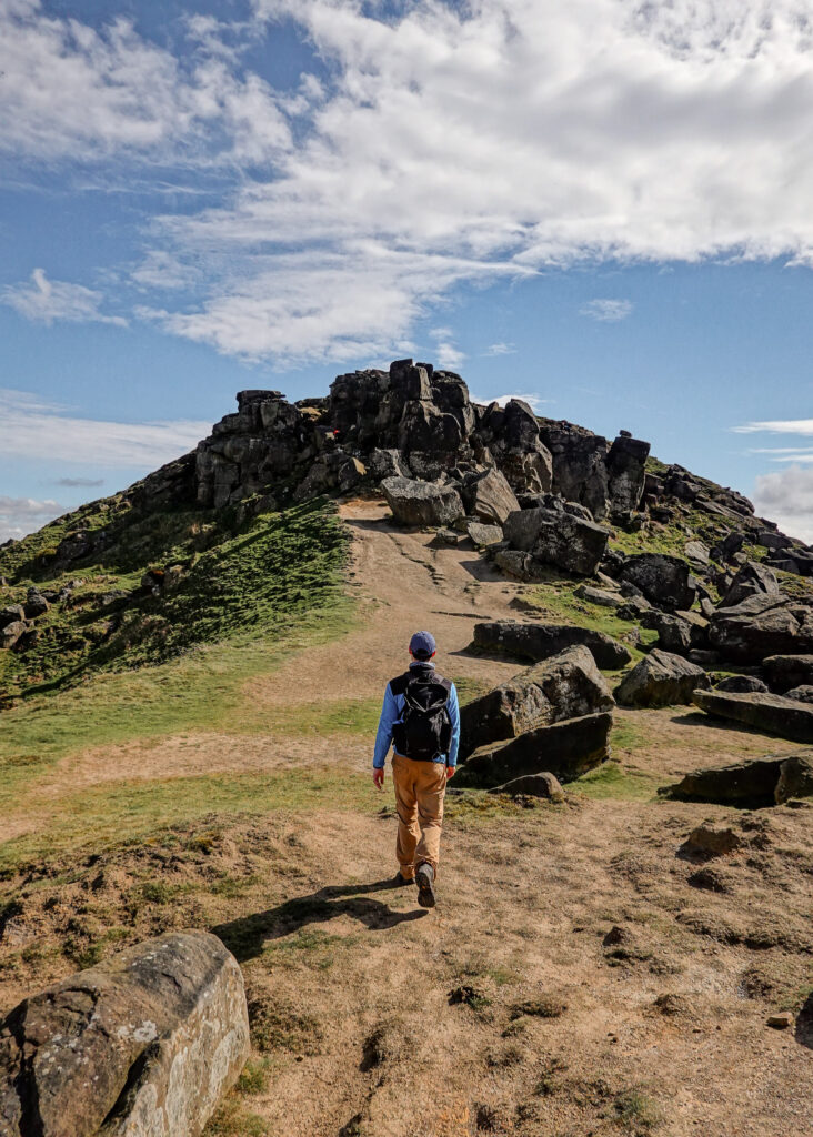 Dan walks towards sandstone rocks known as the Wainstones
