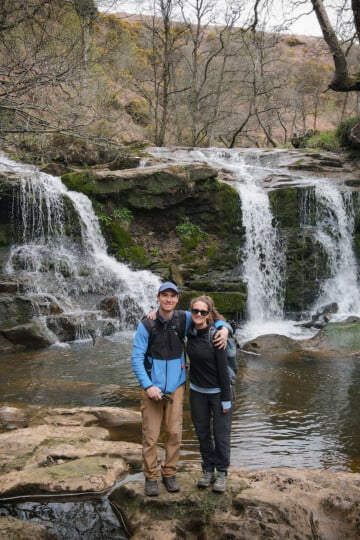 Dan and Beck stand near a waterfall called Water Arc Foss in the North York Moors