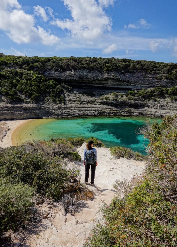 Beck stands and looks at a beach during a walk called Strada Vecia Madonetta