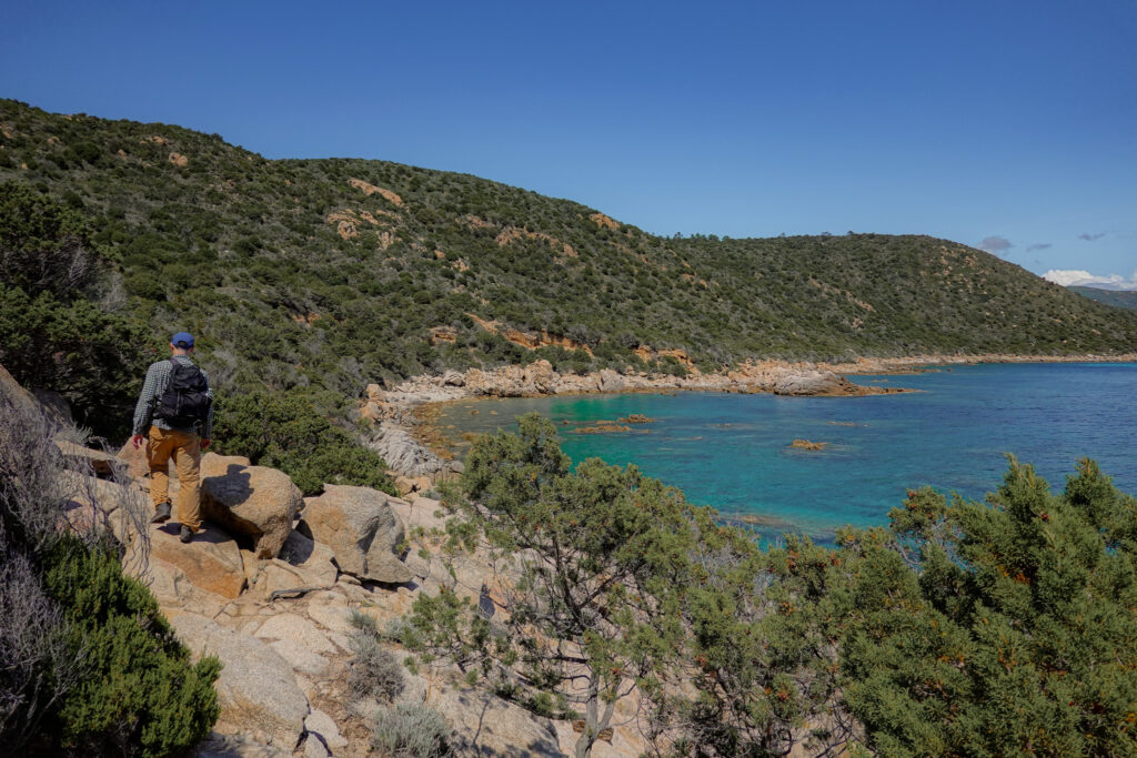 Dan walks alongside a coastline on Capu di Muru