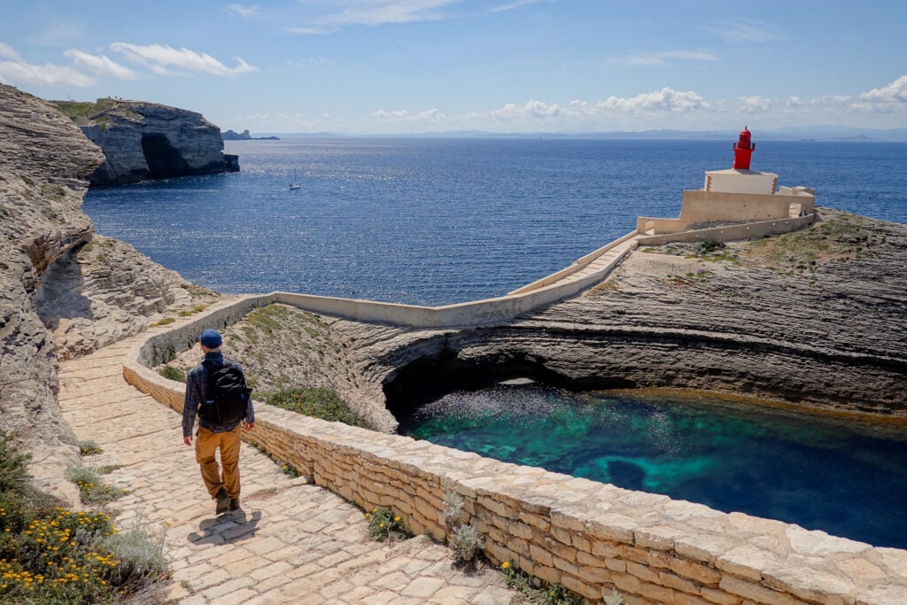 Dan walks down a set of stone steps towards Madonetta Lighthouse