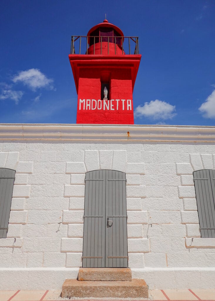 A close-up portrait photograph of a red-tipped white coloured lighthouse called the Madonetta Lighthouse