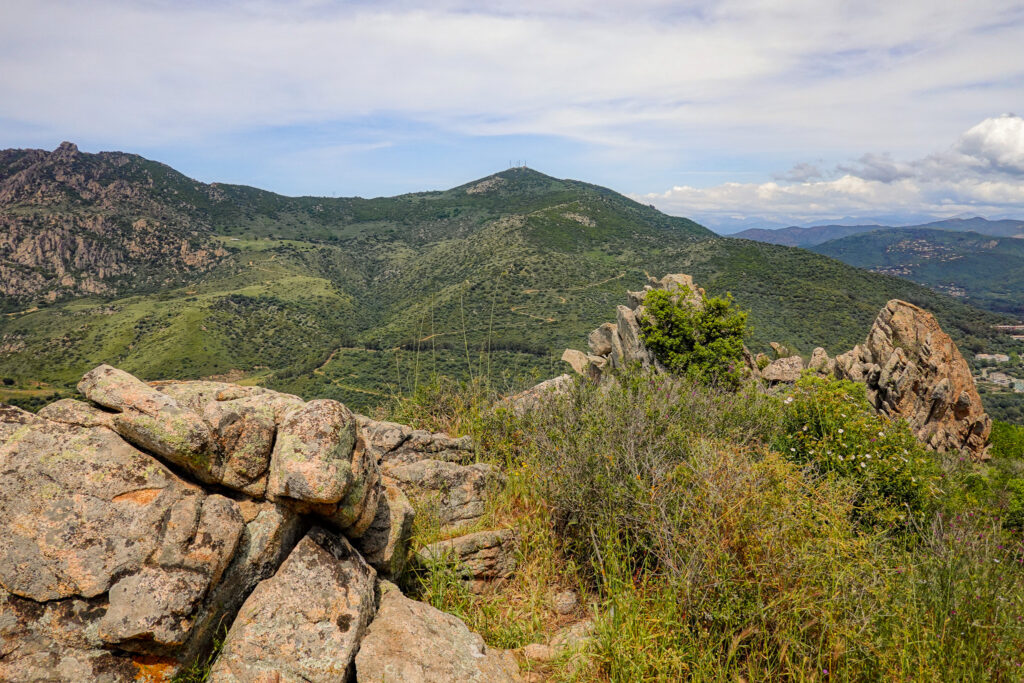 Views of green mountains from atop a peak called Monte Salario on the Sentier des Crêtes Ajaccio High Crest Trail