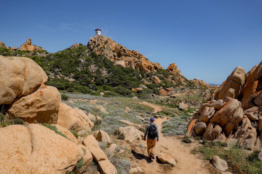 Dan walks towards a lighthouse on Capu di Muru