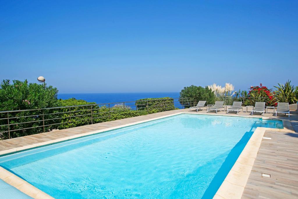 A pool with an ocean in the background