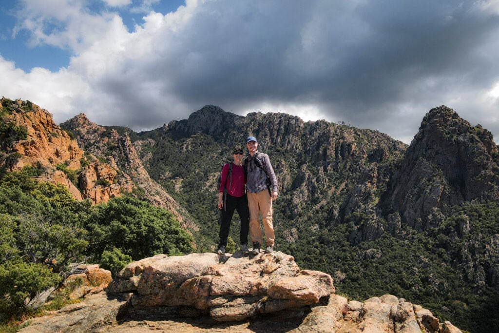 Beck and Dan embrace on a rock platform during a walk called Sentier du Château Fort Piana