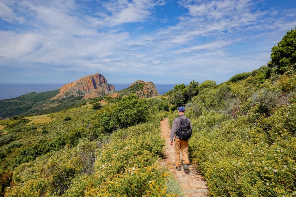 Dan walks on the Capo Rosso Hiking Trail on a partly cloudy day
