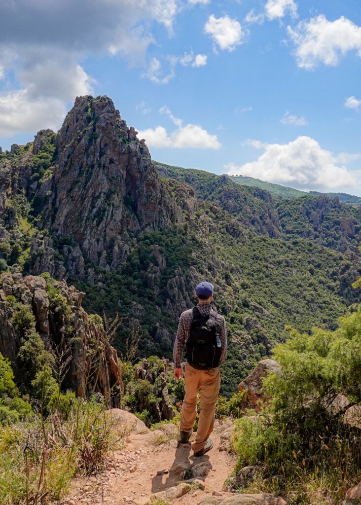 Dan looks at the rocky mountainous scenery during a hike called Sentier du Château Fort Piana