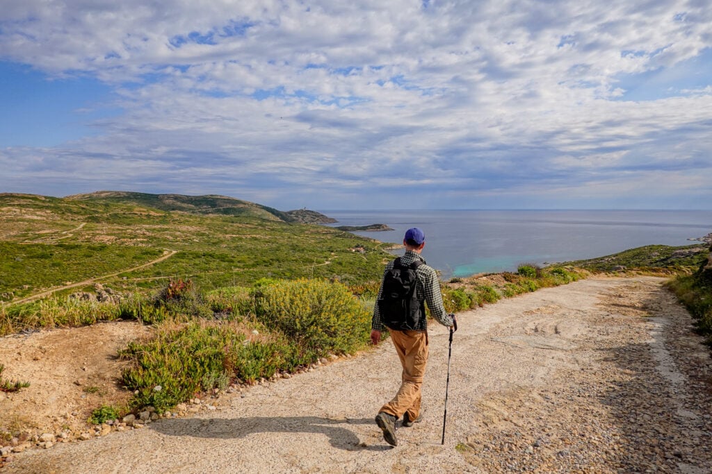 Dan walks down a wide path on a peninsula in Corsica called Pointe de la Revellata