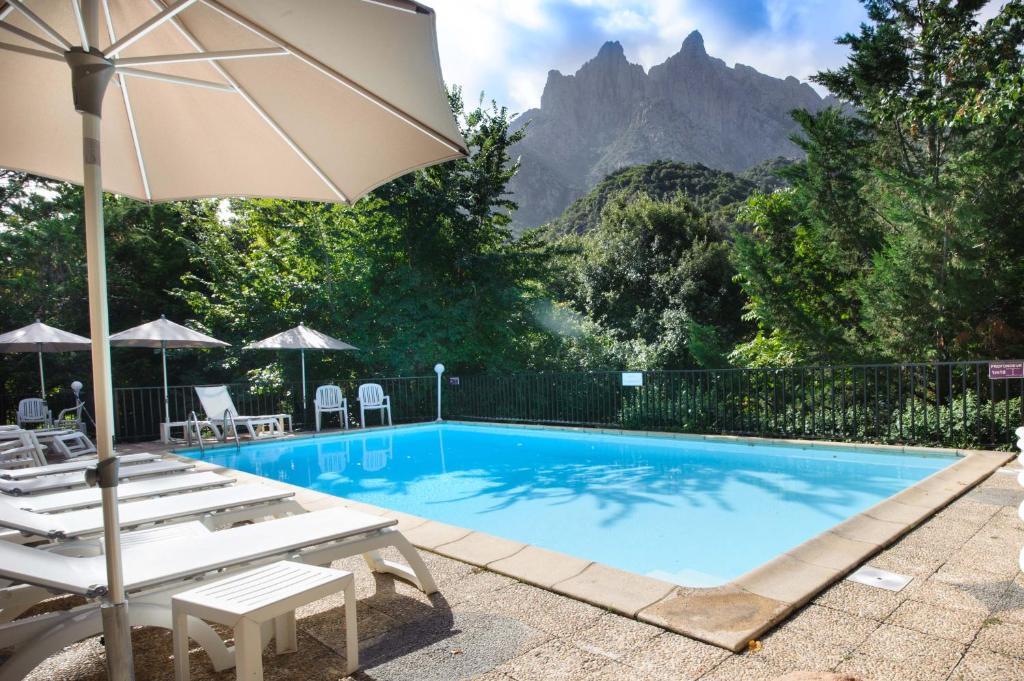 A hotel pool with natural surrounds