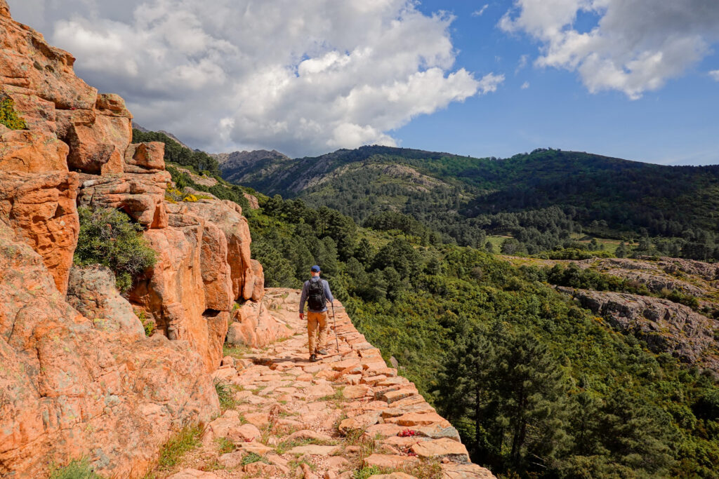 Dan walks on a balcony-like trail called Sentier Muletier on the Calanques de Piana Hike