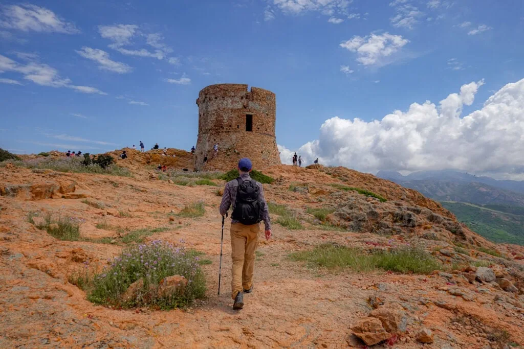 Dan walks towards a tower during the Capo Rosso Hiking Trail