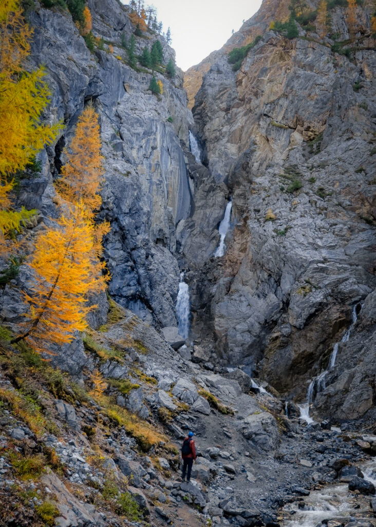 Dan looks up at a multi-tier waterfall called Sertig Waterfall