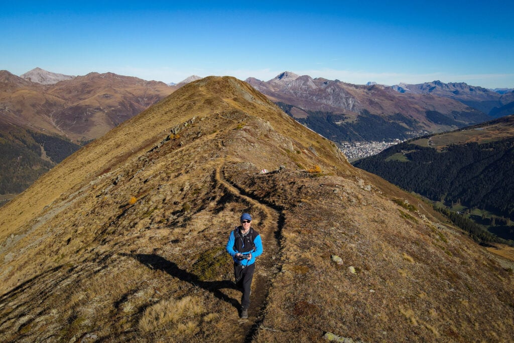 Dan walks along a mountain ridge during one of the best hikes in Davos