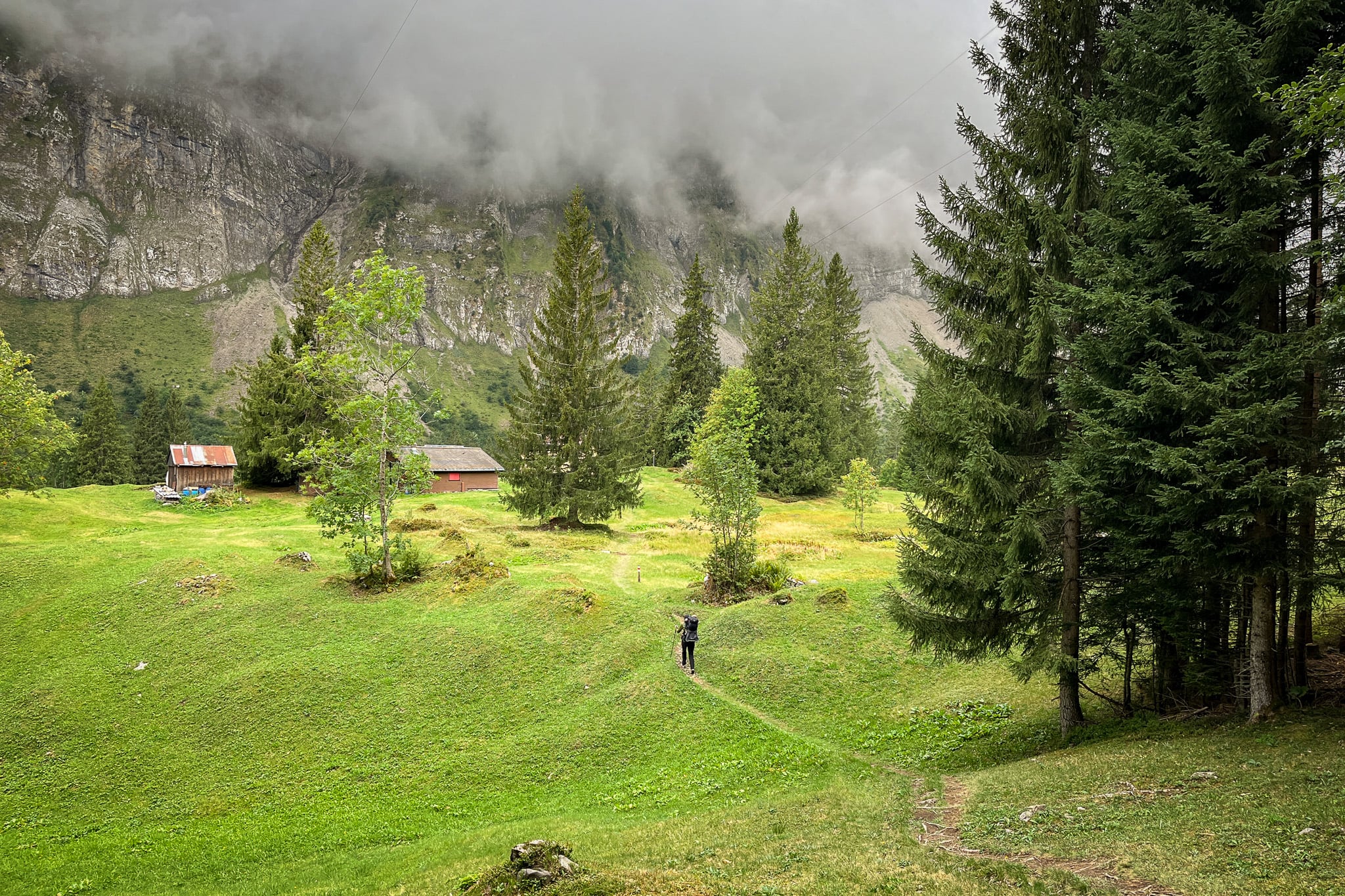 Beck walks on a trail approaching mountains during a hike called Ahornen Rundweg